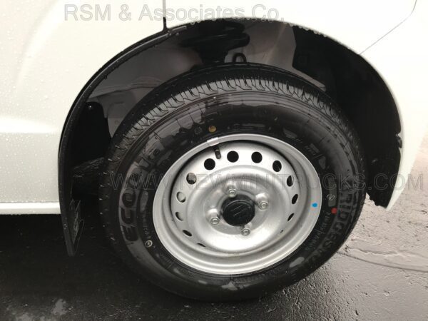 A black tire with a silver rim on the side of a car.