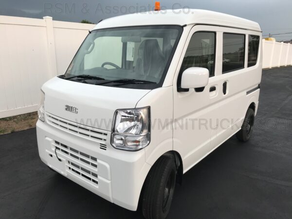 A white van is parked in the parking lot.