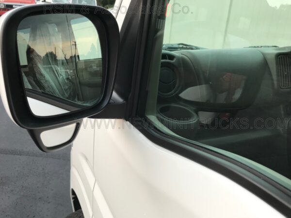 A side view mirror of a truck on the road.