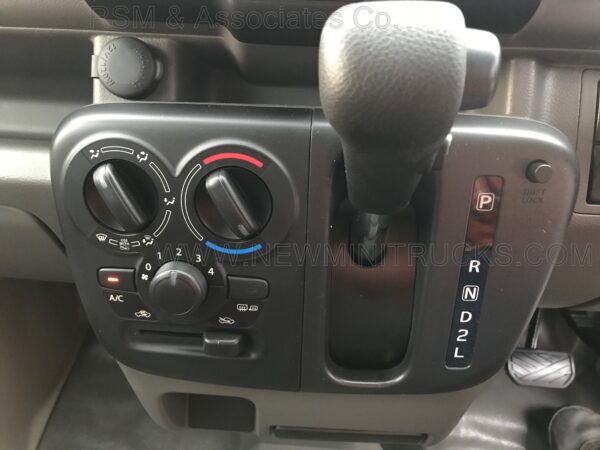 A close up of the dashboard controls on an automobile.