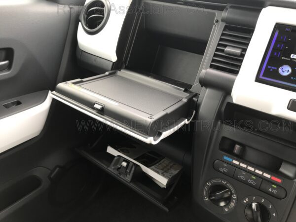 A laptop on the back of a car seat.