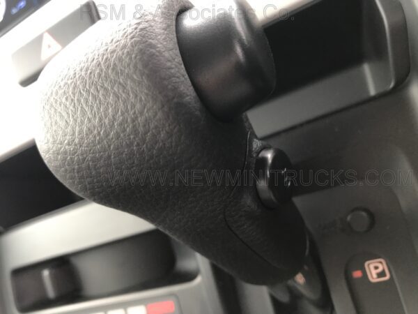 A close up of the steering wheel and shift knob.