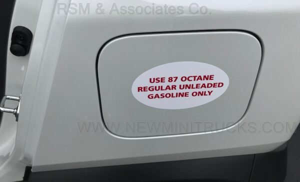 A sticker on the side of a car that says " use 8 7 octane regular unleaded gasoline only ".