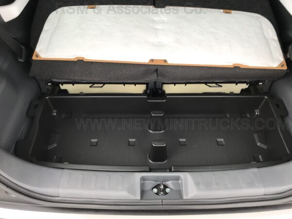 A trunk compartment of an automobile with the lid open.