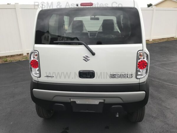 A rear view of the back end of a white van.