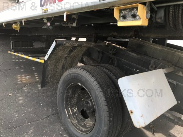 A truck with the tire on it's side.