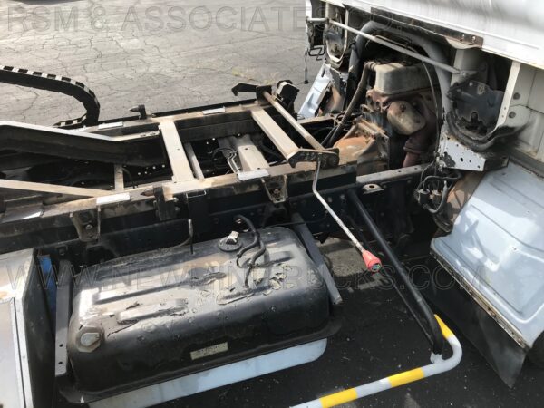 A truck with the hood up and its engine bay in view.