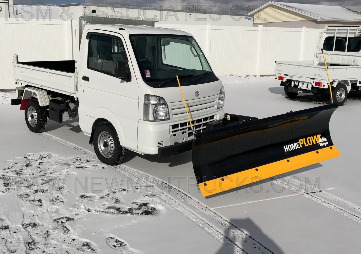 a plow attached on the front of a mini truck
