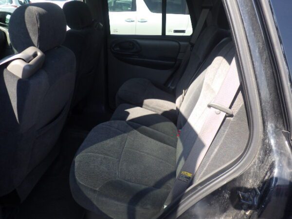 A car seat in the back of a vehicle.