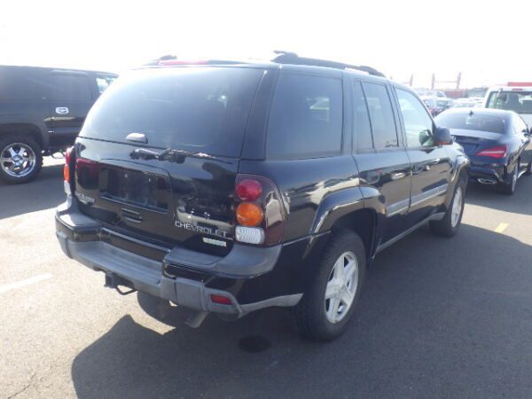 A black suv is parked in the parking lot.