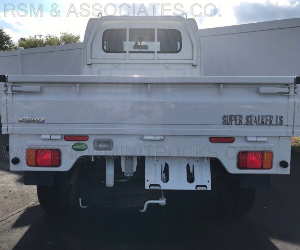 A white truck with the back end of it.