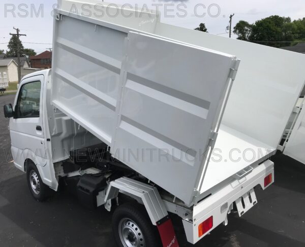 A white truck with its back open on the street.